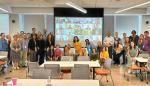 photo of team group standing in front of a screen